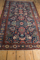Perspective view down the length of the vintage Mehreban rug's allover floral pattern.