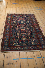 Angled view of a vintage Mehreban rug highlighting its floral field and serpent border.