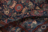 Detail of a folded vintage Mehreban rug showing the dense, hand-knotted pile and floral motifs.