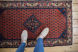 Persian Engelas rug: madder red field, allover botehs, sapphire medallion, Herati motifs.