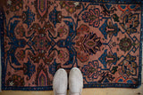 View from above showing the even pile of a vintage Mehreban rug in dusty rose and sapphire.