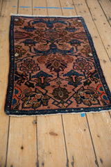 Vintage Persian Mehreban rug from an angle, showing its dusty rose and indigo pattern.