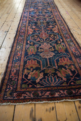 Vintage Persian Lilihan runner's columned plant motif, navy field, raspberry border, and machine-bound edge.