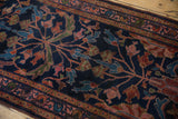 Close-up of the Persian Lilihan runner's deep navy field and intricate floral pattern.