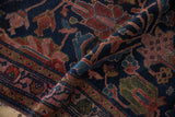 Lustrous vintage Lilihan rug pile showing navy, raspberry red, and green vine motifs.