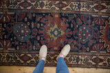 Vintage Hamadan runner showcasing Harshang arabesque, blossoms, and Herati motifs in navy, copper, ivory.