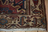 Machine binding on vintage Hamadan rug, showing geometric pattern and fringe.