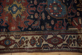 Hamadan runner border detail featuring ivory, deep copper, navy motifs, and machine binding.