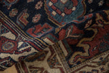 Folded vintage Hamadan runner's richly textured pile, showcasing navy, deep copper, and celadon tones.