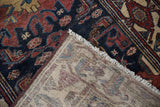 Vintage Hamadan rug runner's hand-knotted foundation, fringed edge, and machine binding.