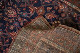 Vintage Kurdish Hamadan rug with deep navy Herati design and its hand-knotted foundation.