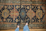 Vintage Persian Malayer rug's navy field, sand and blush geometric motifs, intricate borders.