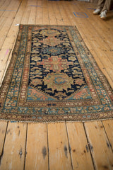 Vintage Malayer rug corner, intricate navy blue field, blush, sky blue motifs, and fringe.