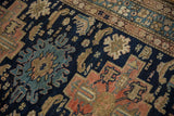 Close-up of vintage Malayer rug field with sand serpents and sky blue serrated leaves.