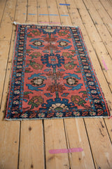Vintage Lilihan rug corner, dusty brick red field, indigo and sky blue borders with tattered ends.