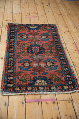 Vintage Lilihan rug's central column with brick red and blue medallions, showing pile wear.