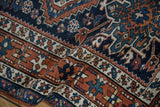Geometric patterns and starburst border of a vintage Karaja rug in navy, chestnut, ivory.