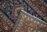 Vintage Karaja rug corner showing hand-knotted back weave, white fringe, and copper selvedge.