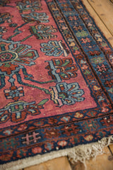Detail of vintage Persian Lilihan rug, pale raspberry field, blue and green blossoms.