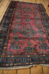 Raspberry red Lilihan rug with double medallions, long stemmed blue and green blossoms.