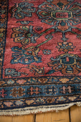 Vintage Lilihan rug detail: Raspberry red field, blue floral patterns, cobalt border, and worn edge.