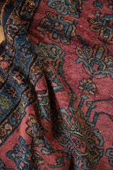 Textured pile of the Lilihan rug showcasing long-stemmed blossoms in raspberry, blue, and green.