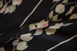 Hand woven flatweave of black Romanian Kilim runner, showing ivory and mauve floral motifs.