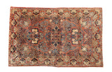 Vintage Persian Sarouk rug featuring dusty rose, navy and blue floral blossom bouquet. 4'3
