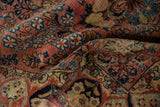 Rich pile texture and dusty rose, navy blue floral motifs of a vintage Sarouk rug.