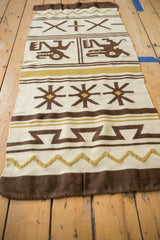 Moroccan Kilim rug runner's base showing brown and dusty gold zig-zag patterns.