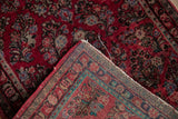 Cherry red allover floral Sarouk rug pile and hand-knotted foundation with tattered edges.