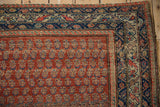 Vintage Hamadan rug upper corner, showing red boteh field, navy borders, mostly even wear.