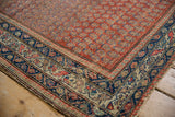 Close-up of intricate navy blue, beige, and red border patterns on vintage Hamadan rug.