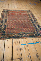 Vintage Hamadan rug's lower border shows abrash, repeating boteh, navy, and dusty red hues.