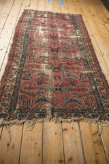 Tattered fringe and worn texture of the Vintage Mehreban rug with dusty plum and teal.