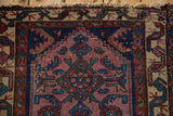Pale violet field of a vintage Mehreban rug, Herati motif, serpent border, worn fringe.