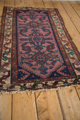 Tattered fringe and minor color migration on vintage Mehreban rug's serpent and boteh borders.