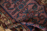 Worn pile of vintage Mehreban rug showing partial Herati design in violet, cobalt, and red.