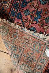 Tattered fringe, patterned pile, and tightly woven foundation of this vintage Lilihan rug.