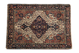 Antique Farahan Sarouk rug: ivory field, dramatic shield medallion, navy palmette border.