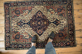 Antique Farahan Sarouk rug's navy lower medallion and ivory field with delicate floral vinery.