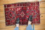 Vintage Karaja rug's textured pile, serrated red medallion, and geometric blossoms.