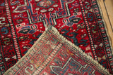 Vintage Karaja rug, folded to show hand-knotted foundation and cherry red geometric pile.