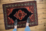 Vintage Malayer rug mat with its dark field and red geometric medallion shown to scale.