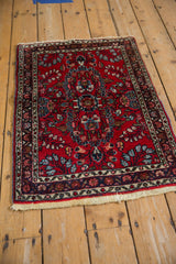 Vintage Persian Lilihan rug corner detail, cherry red floral field, original blue selvage.