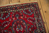 Vintage Persian Lilihan rug corner detail, cherry red field, blue florals, intact selvage.