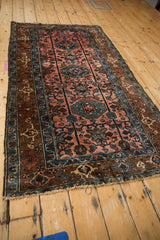Vintage Lilihan rug's thick banded vines and triple medallion detail in rose and sapphire.