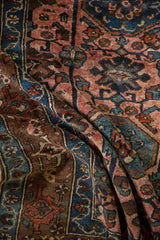 Lilihan rug detail: intricate rose, sapphire, bronze vines and sharp palmettes on folded pile.