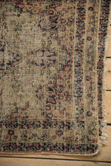 Antique Kerman rug with large areas of foundation showing, tattered sides, and worn knot heads.