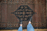 Antique Malayer rug with serrated stepped navy medallion and dusty blush boteh field.